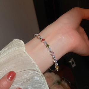 Detail of silver bangle with multicolored cubic zirconia in square and marquise cuts