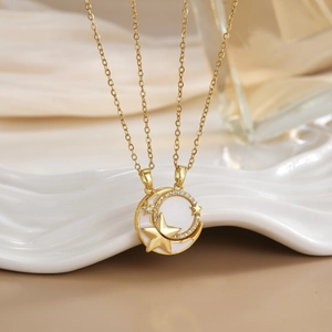 Detail of gold star and moon pendant with pavé cubic zirconia on a delicate chain