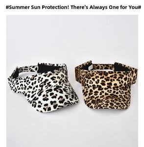 Flat lay detail of leopard print sun visors in cream and brown with adjustable straps