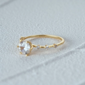 Macro view of S925 engraved stamp and luxurious round-cut diamond on a gold-plated ring
