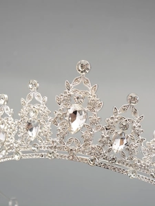 Detailed macro view of an elegant silver bridal crown with sparkling crystal teardrops