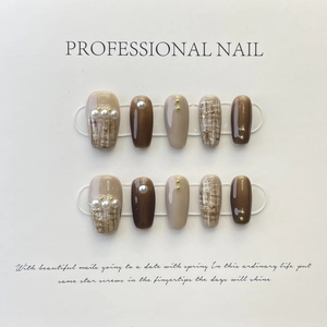 Handmade caramel and nude press-on nails with hand-painted plaid and pearl accents