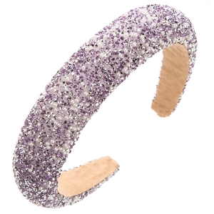 Detailed macro view of purple rhinestones and white pearls on wide padded headband