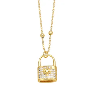 Gold lock pendant necklace with zircon pavé and starburst detail on beaded chain
