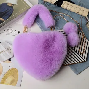 Chic heart-shaped faux fur handbag in purple with gold chain and plush pompoms