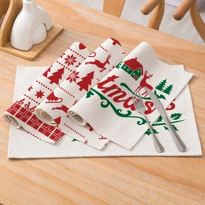 Christmas cotton linen placemat with festive reindeer and tree print on table