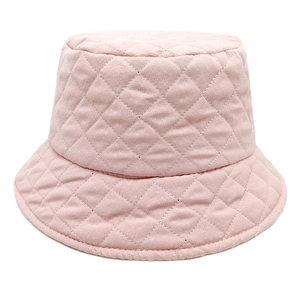 Detailed close-up of light pink quilted bucket hat with classic diamond stitch pattern