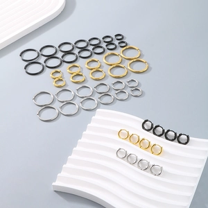 Detailed close-up of smooth geometric hoop earrings in various sizes and metallic finishes