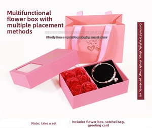 Pink jewelry gift box with transparent window, six red roses and silver metal bracelet