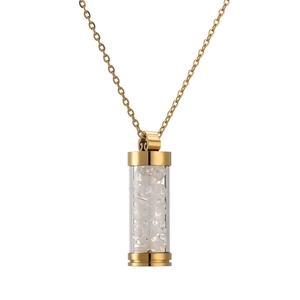 Detail of gold necklace with cylindrical glass pendant filled with white crystal stones