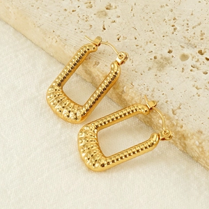 Square 18K gold plated stainless steel hoop earrings with hammered texture on travertine