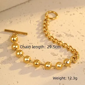 Detail of mixed-link golden steel bracelet with round beads and classic OT toggle clasp