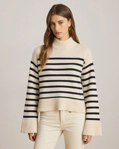 Detailed view of striped knit sweater texture with high collar and loose sleeve design