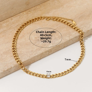 Detail of gold-plated stainless steel chunky Cuban link necklace with round cubic zirconia