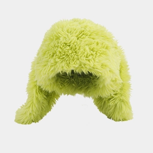 Close-up of bright neon green faux fur winter hat with soft fluffy texture and ear flaps