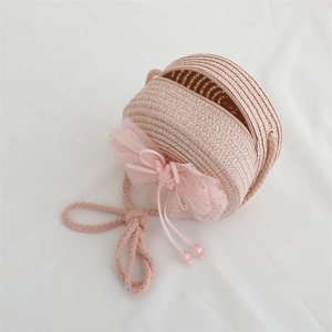 Pink woven straw crossbody bag for girls with large mesh bow and floral details