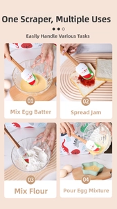 Detail showing Santa silicone spatula mixing batter and spreading jam with wooden handle