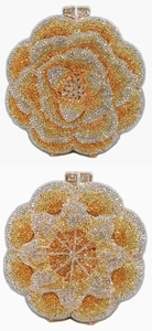Macro view of rose-shaped evening clutch bag with champagne and gold crystals