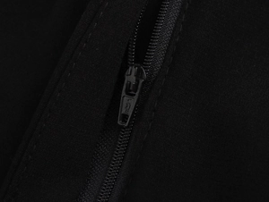 Close-up of a high-quality black YKK metal zipper on an elegant sleeveless jumpsuit