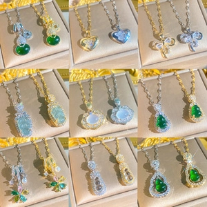 Detailed grid of gold clover necklaces with heart and flower pendants on jewelry boxes