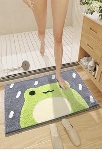 Detail of absorbent frog pattern bathroom mat with soft flocking texture in a home setting