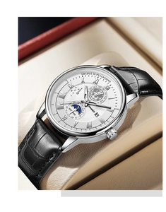 Macro detail of men's leather watch with multi-function white dial in a beige box