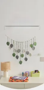Detail of bohemian handmade woven leaf wall hanging with cotton rope and wooden beads