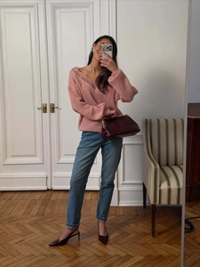 Chic pink knit sweater with delicate lace trim neckline and relaxed drop shoulder design