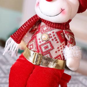 Macro detail of Christmas doll showing gold belt, knitted fabric, and velvet pants texture
