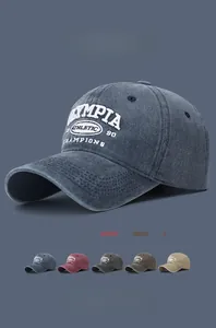 Close-up of OLYMPIA ATHLETIC 90 embroidery on washed cotton baseball caps in 5 colors