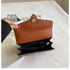 Detail view of the brown crocodile pattern bag showing inner double compartments and lining