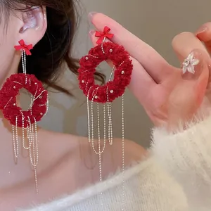 Red plush hoop earrings with silver fringe chains and festive bow for women