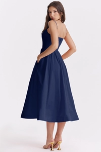 Detail view of the open back design and side pockets on the navy blue midi dress