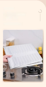 Detail of the rolled edge on a silver aluminum oil splatter screen for kitchen safety