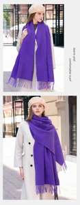 Detailed close-up of a purple cashmere blend scarf with soft tassels and warm texture