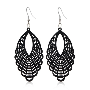 Detailed view of black hollow teardrop wooden earrings with elegant geometric patterns