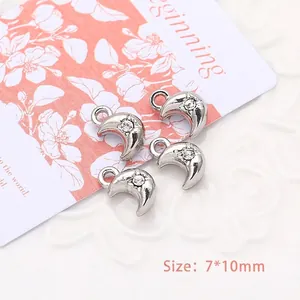 Close-up of 7x10mm silver moon charms with rhinestones for DIY jewelry making