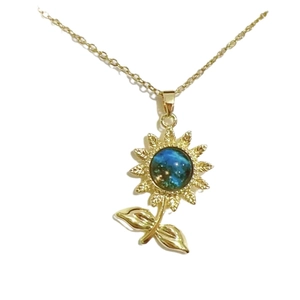 Golden sunflower necklace featuring a gradient starry sky pendant with crystal details