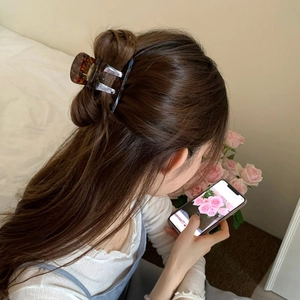 Brown tortoise shell acrylic hair claw clip for elegant updo hairstyles in warm tones