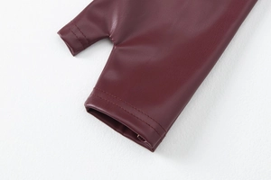 Detailed close-up of wine red PU leather sleeve with premium stitching and thumbhole cuff
