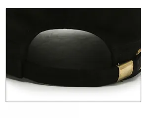 Close-up of adjustable strap with bronze metal buckle on a black twill cotton military cap