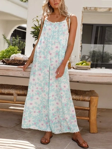 Detail of bohemian floral jumpsuit with lace trim and elegant draped fabric