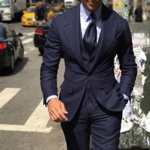 Close-up of a navy blue slim-fit three-piece suit with a vest and tie for formal events