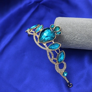Detailed view of princess tiara featuring a large blue heart crystal and golden frame