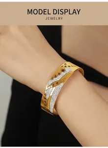 Detail of 18K gold plated bangle with hollow flower patterns and pave-set crystals