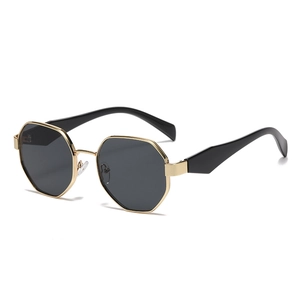 Modern polygonal metal sunglasses with black lenses and gold frames in 45-degree angle