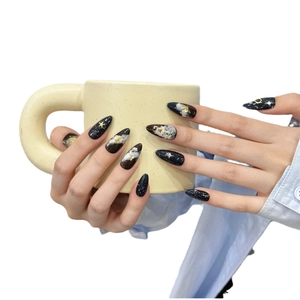 Handcrafted starry night press-on nails with gold celestial motifs and galaxy patterns