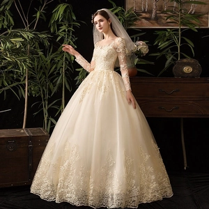 Elegante abito da sposa in pizzo a maniche lunghe con un magnifico strascico lungo