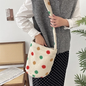 Detailed close-up of plush bucket bag with colorful polka dots and fuzzy texture