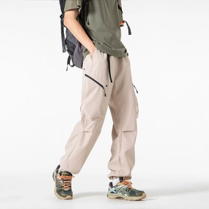 Men's khaki cargo pants with waterproof zipper pockets in a stylish outdoor hiking style